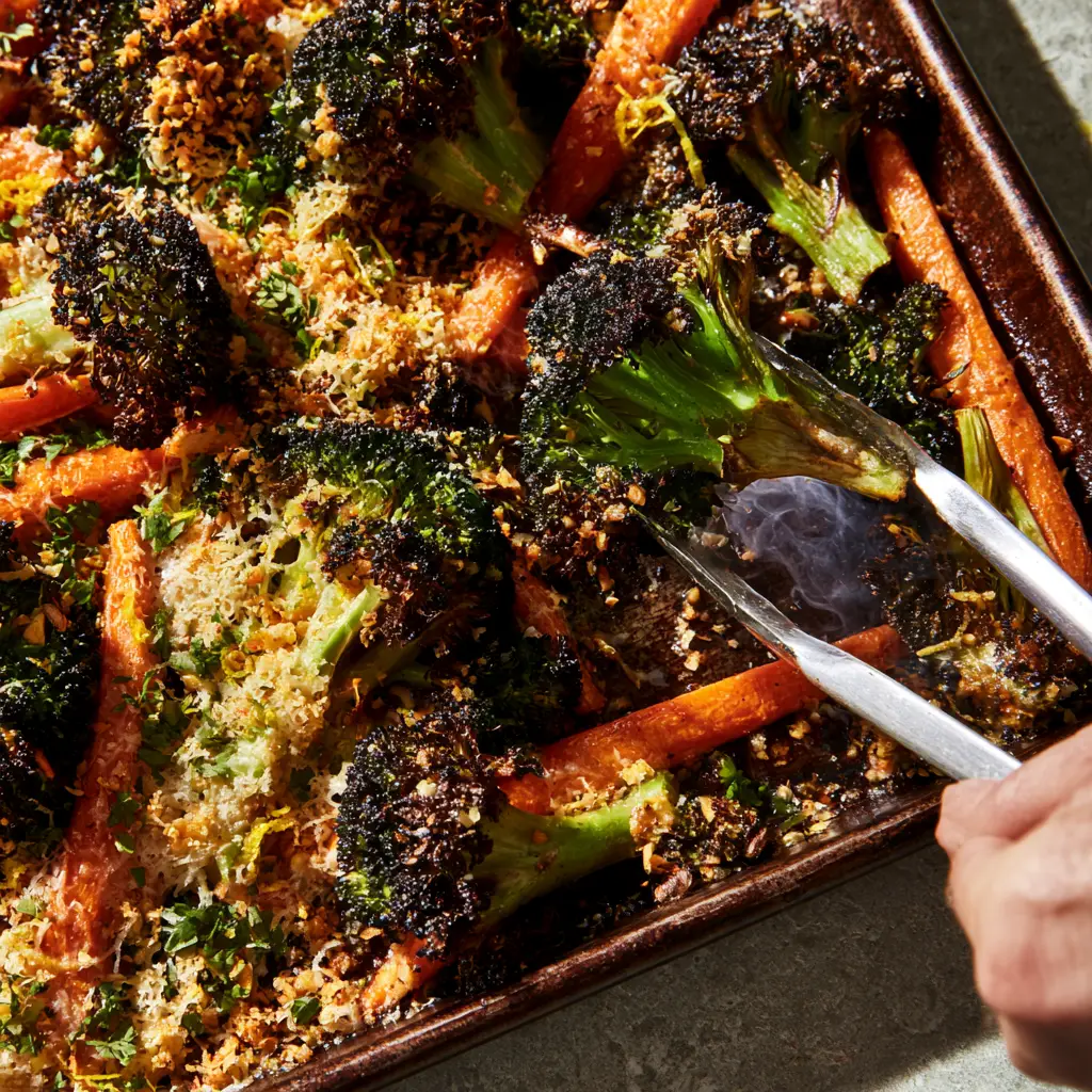 Roasted Broccoli and Carrots with Crispy Garlic Parmesan Crust 2 Top-down view of roasted broccoli and carrots with golden toasted garlic and fresh parsley. (roasted broccoli and carrots)
